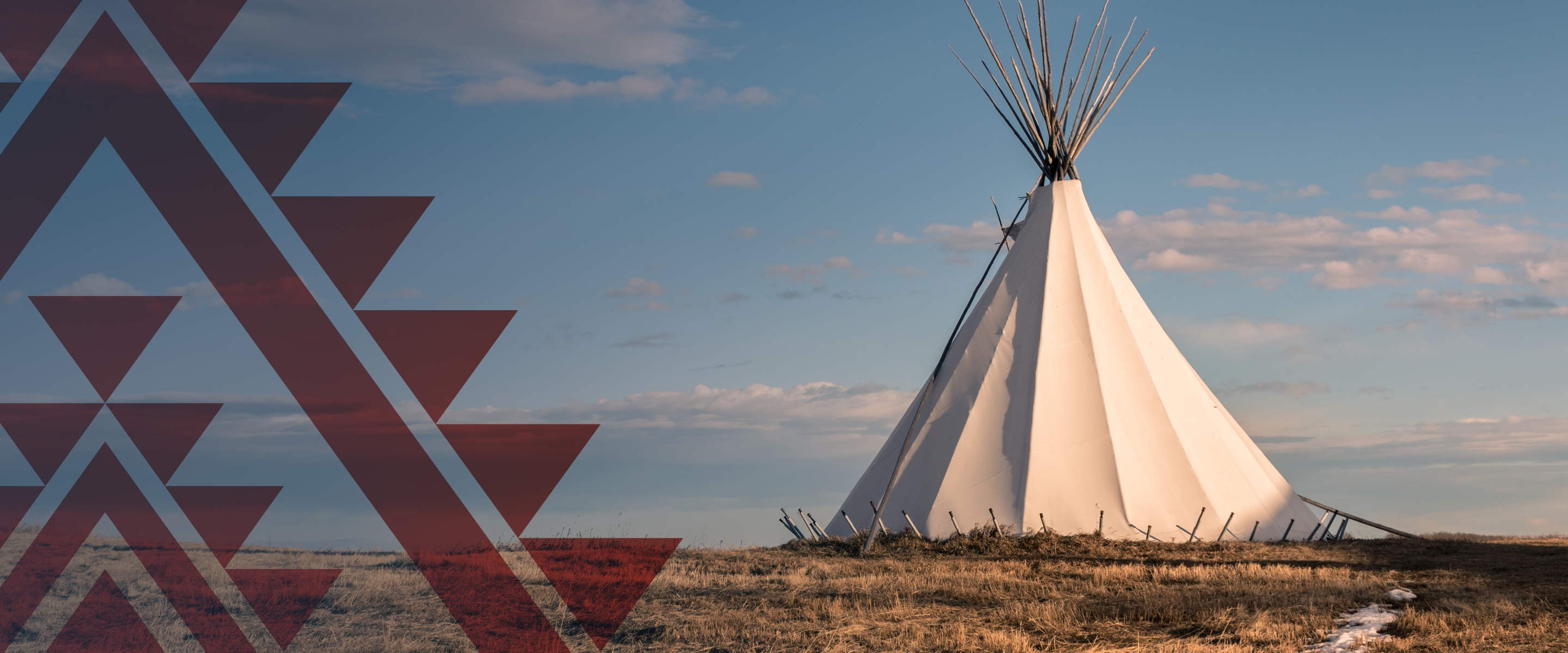 White Teepee with a blue sky in the background.