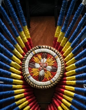 Close up image of a embroidered medicine wheel medalion.