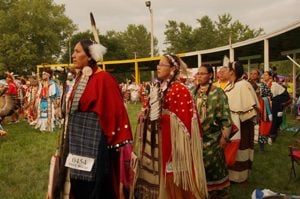 Native American women wearing traditional dress at a Pow Wow.